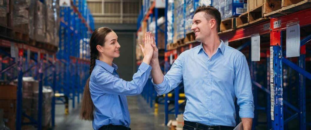 Two 3PL warehouse managers giving each other a high five