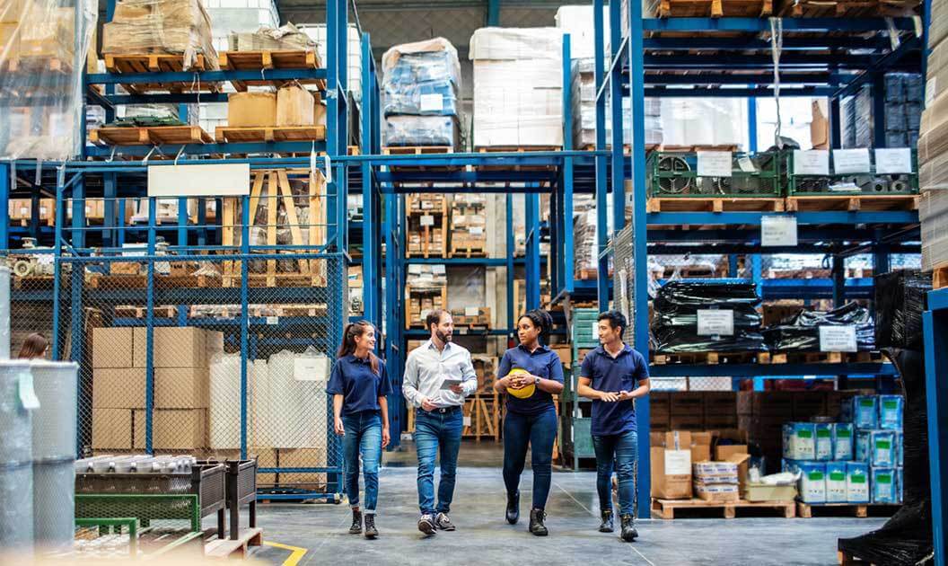 Group of workers walking through a warehouse