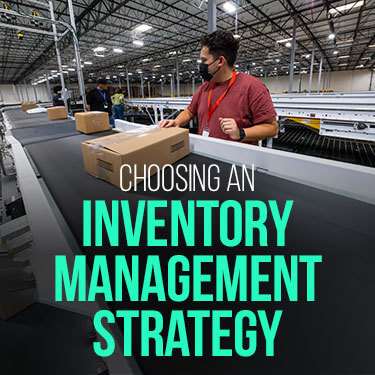 Warehouse worker on standing by box conveyor belt 