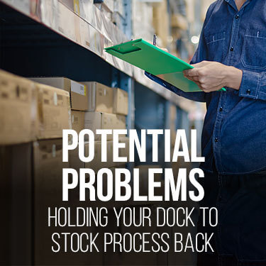 A warehouse worker with a clipboard standing in front of shelves of boxes