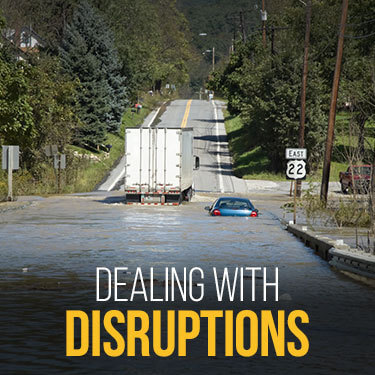 Truck and car stalled out on flooded highway