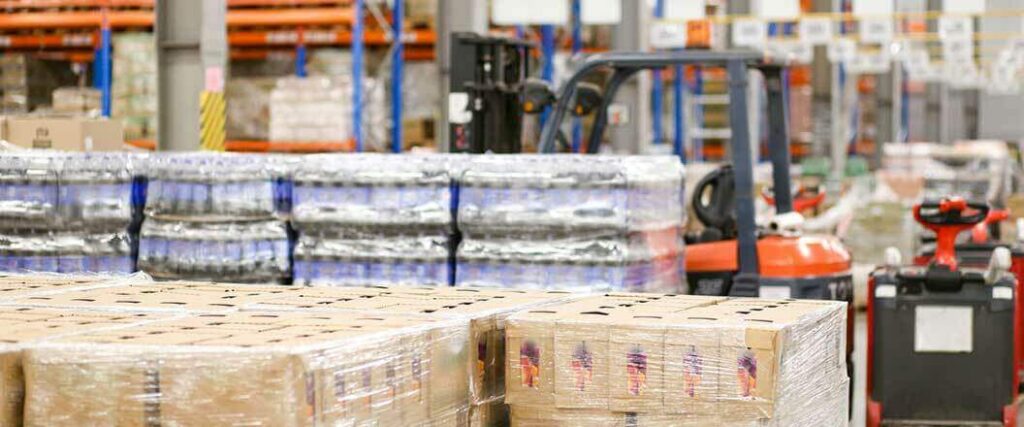 Palletized boxes and water bottles inside a warehouse